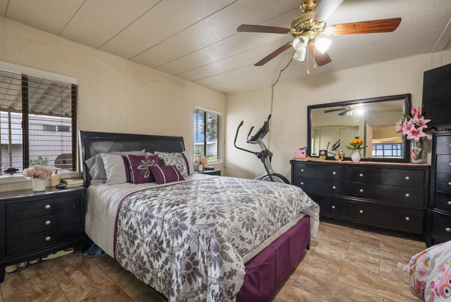 2845 East Hatch Road, Unit 84 Ceres, CA 95351 - Photo 23 of 39 a bedroom with a bed and a mirror on the dresser