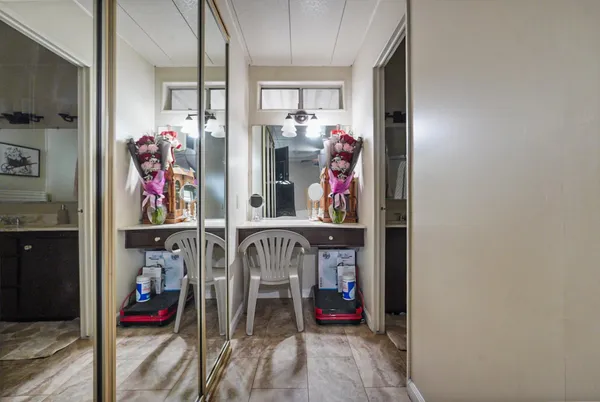 a bathroom with a granite countertop sink a mirror and a shower