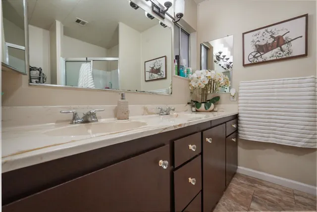 a bedroom with bed and wooden floor