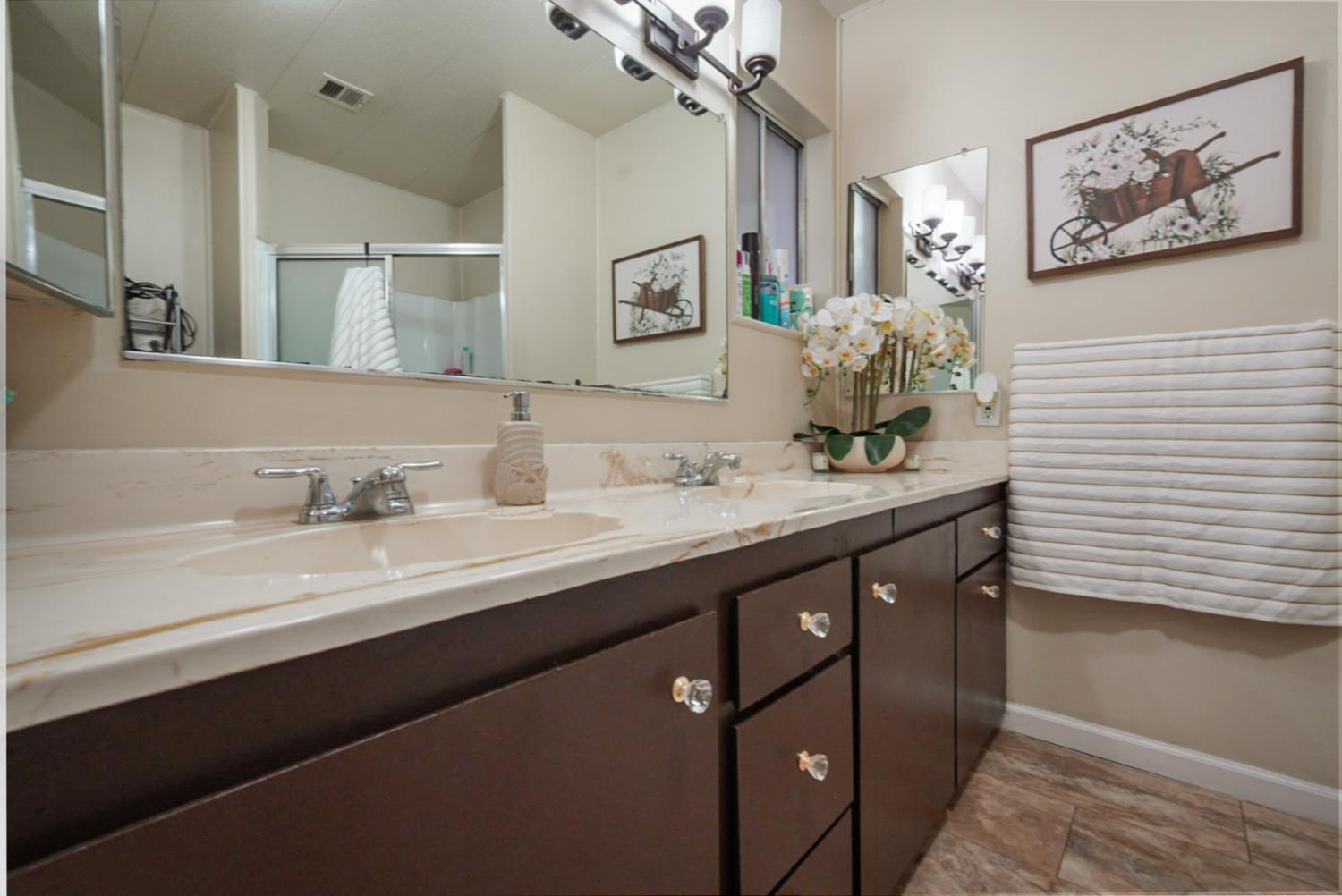 2845 East Hatch Road, Unit 84 Ceres, CA 95351 - Photo 25 of 39 a bathroom with double sink and a mirror
