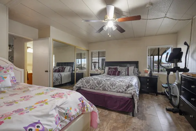 an aerial view of a residential apartment building with a yard and parking spaces