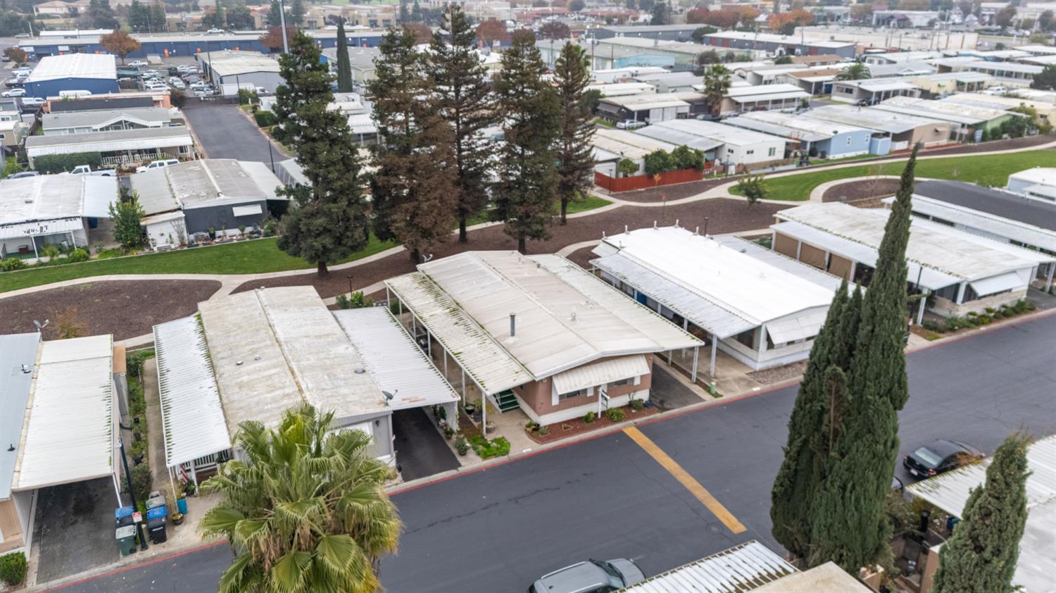 2845 East Hatch Road, Unit 84 Ceres, CA 95351 - Photo 29 of 39 an aerial view of a residential apartment building with a yard and parking spaces