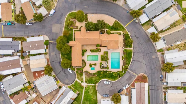 an aerial view of a swimming pool with yard