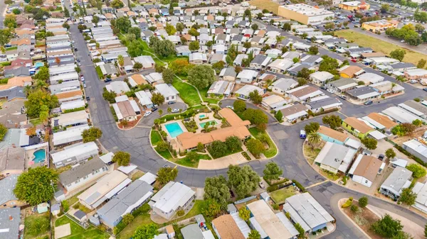 an aerial view of a residential houses with yard