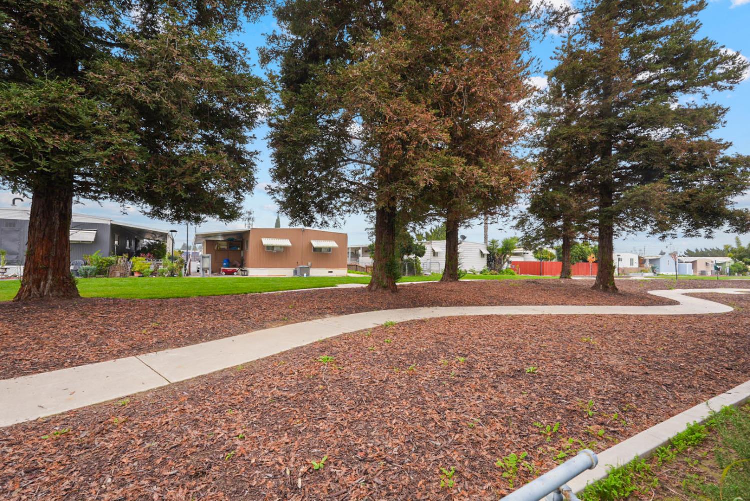 2845 East Hatch Road, Unit 84 Ceres, CA 95351 - Photo 4 of 39 a view of road with large trees