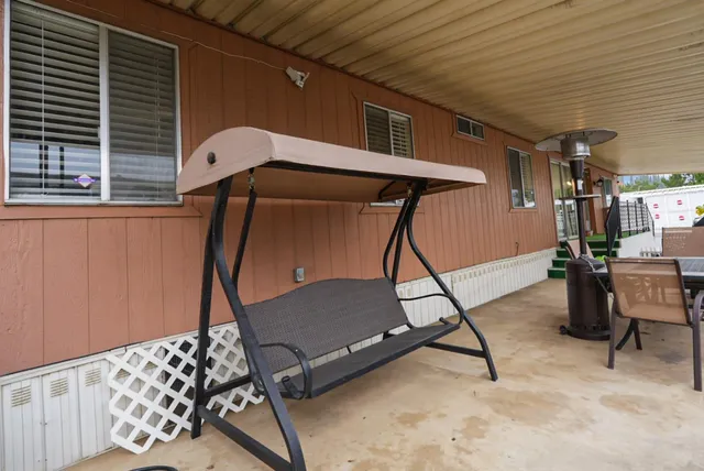 a patio with a table and chairs