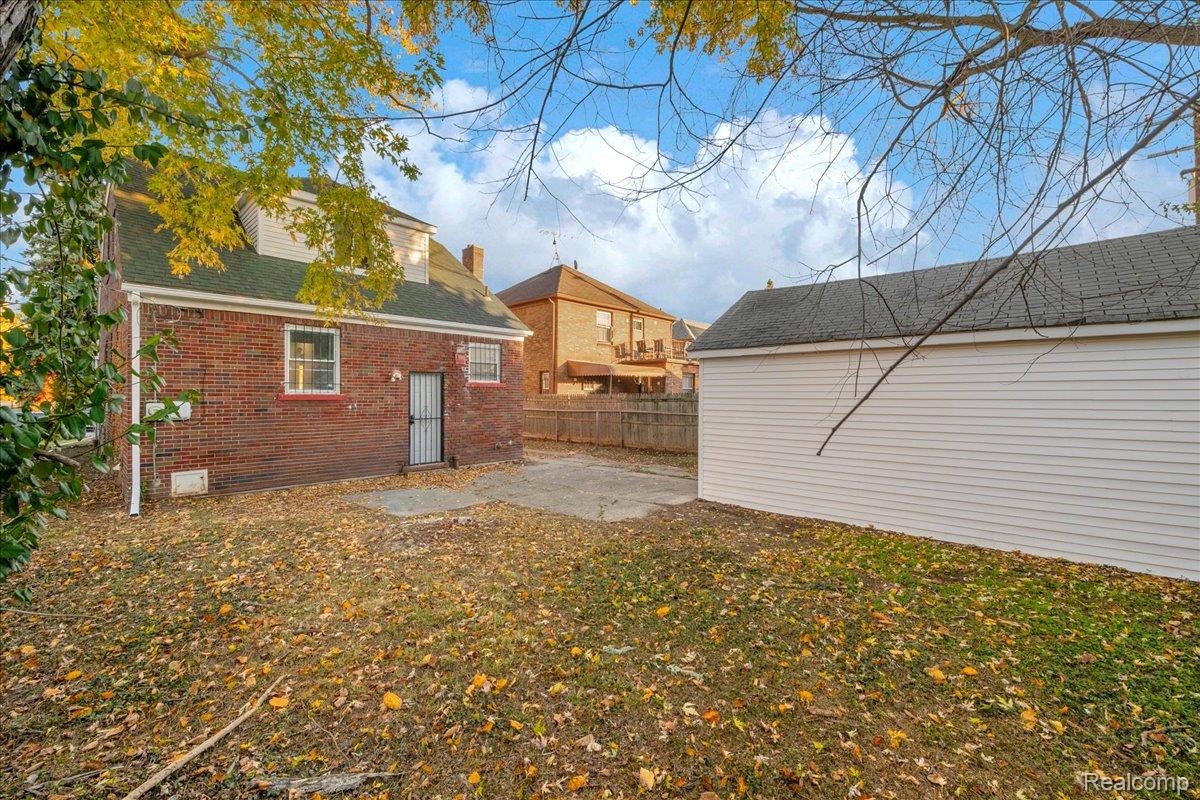 16717 Fielding Street Detroit, MI 48219 - Photo 45 of 46 Back of house with a patio area, brick siding, and roof with shingles