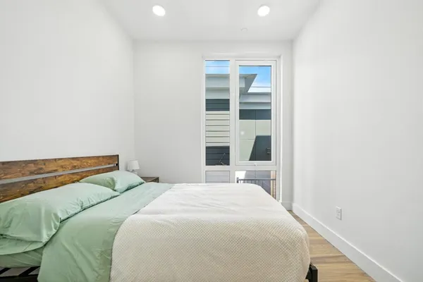 a bedroom with a bed and a window