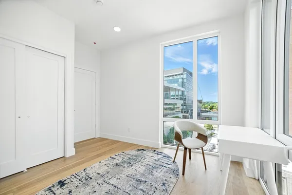 a workspace room with furniture and wooden floor