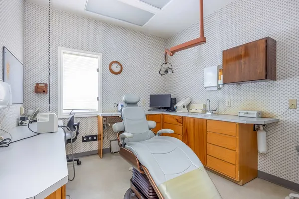 a room with furniture a air conditioner vent and a window