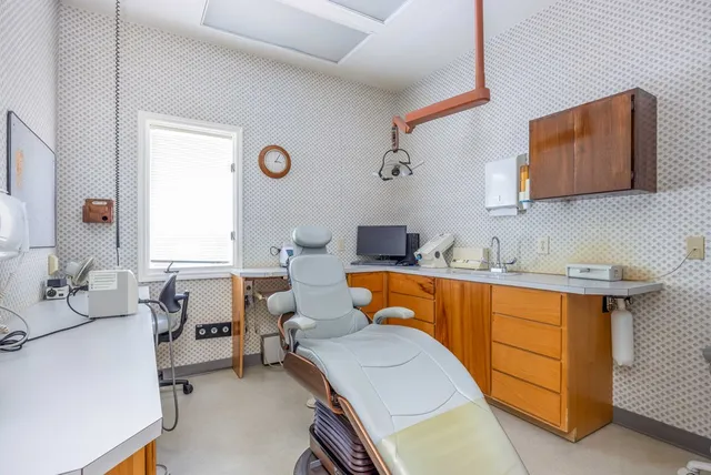 a room with furniture a air conditioner vent and a window