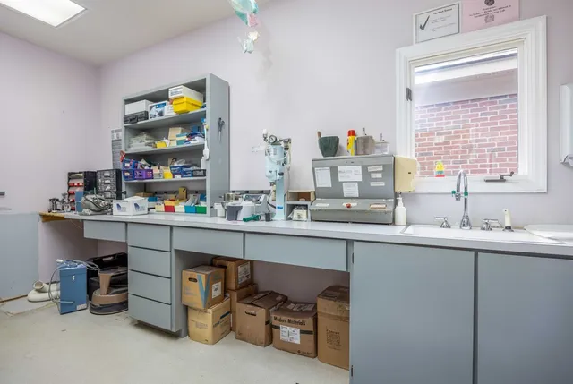 a room with a wooden floor and a sink