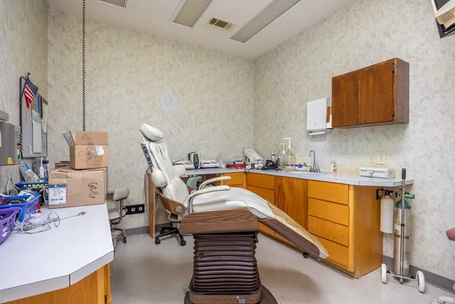 a bedroom with a bed and a dresser in it