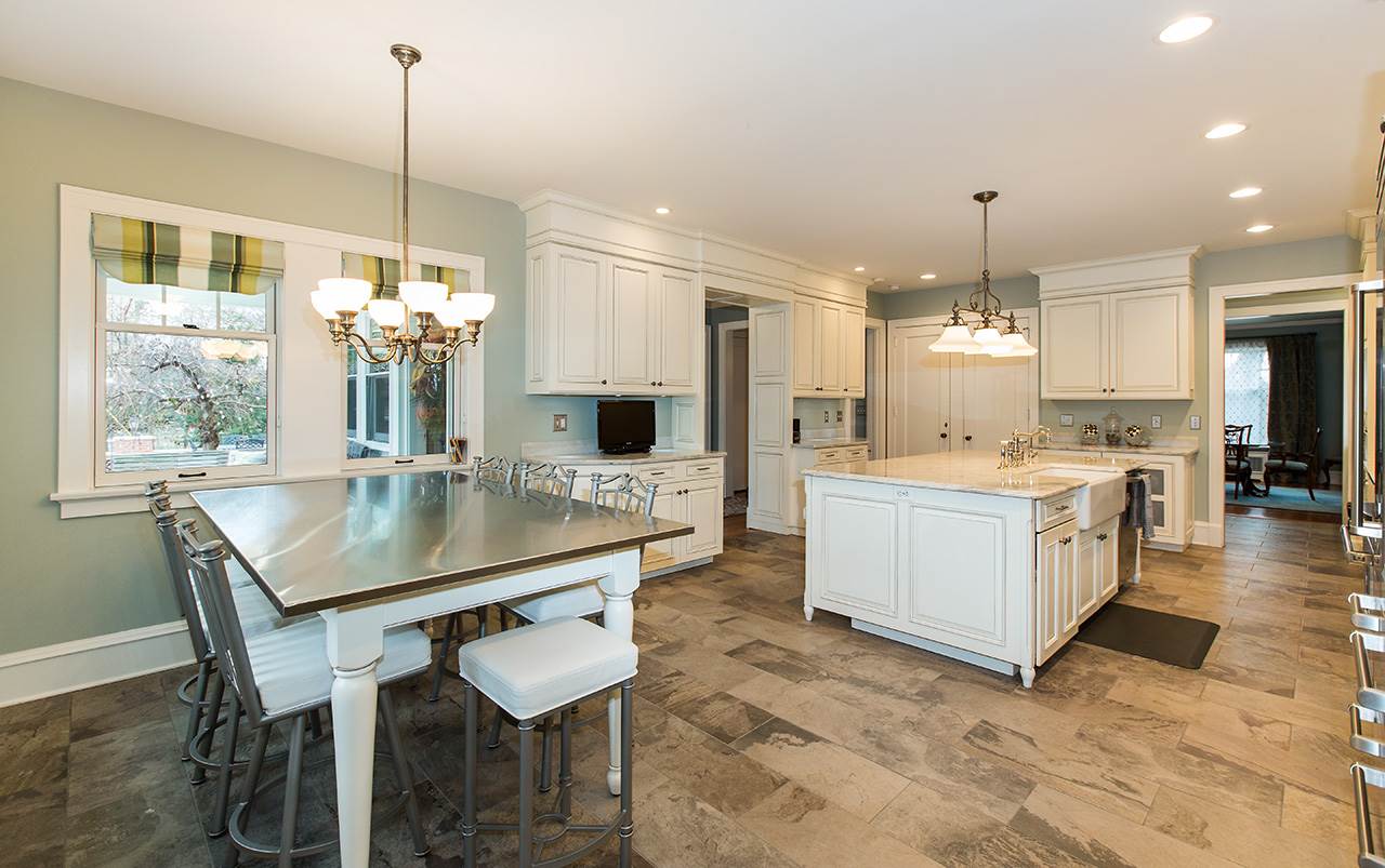 3 Jacoby Place Rockford, IL 61107 - Photo 5 of 25 a kitchen with a table chairs refrigerator and cabinets