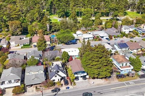 an aerial view of residential houses with outdoor space