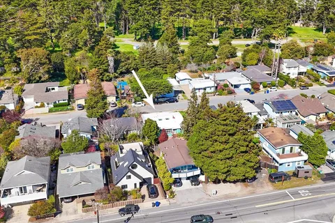 an aerial view of residential houses with outdoor space