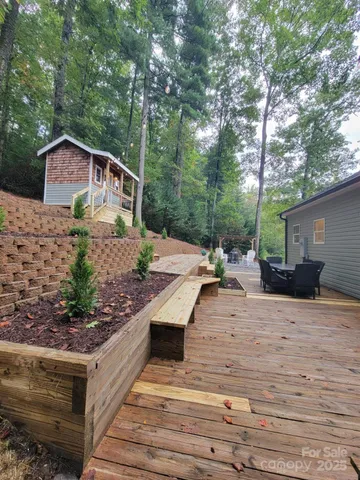 a view of a house with backyard and sitting area