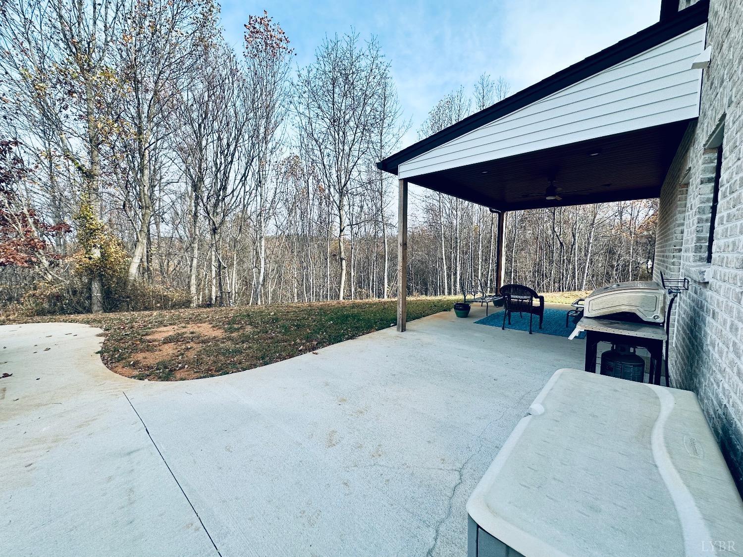 875 Lynbrook Road Rustburg, VA 24588 - Photo 25 of 27 a view of backyard with table and chairs under an umbrella
