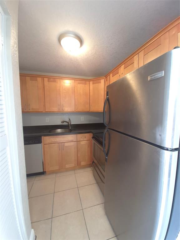 5810 Northeast 14th Road, Unit 6 Fort Lauderdale, FL 33334 - Photo 2 of 9 a kitchen with a refrigerator and a sink