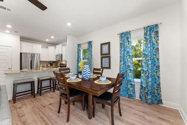 a view of a dining room with furniture window and wooden floor