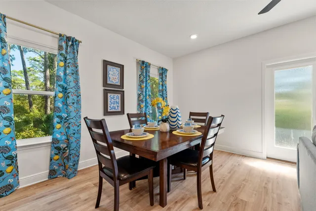 a view of a dining room with furniture window and wooden floor