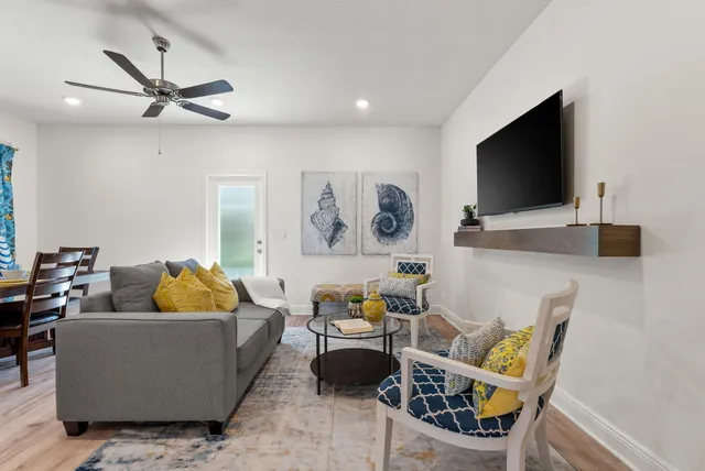 a living room with furniture and a flat screen tv