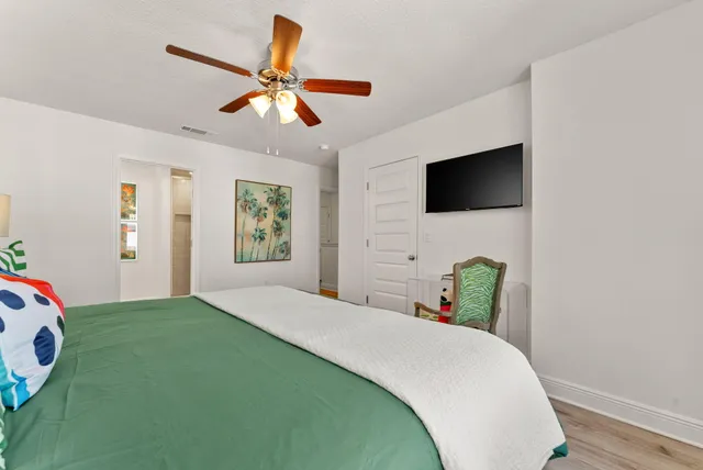 a bedroom with a bed and a flat screen tv