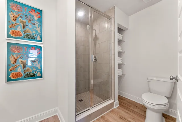 a bathroom with a toilet and a shower