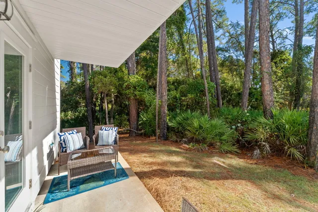 a view of a patio with a couple of chairs and a fountain