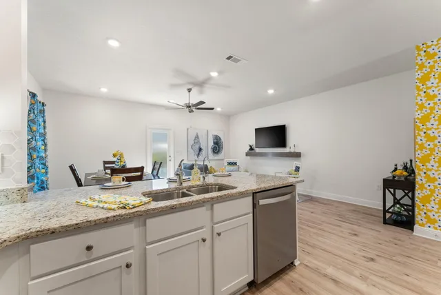 a spacious bathroom with a granite countertop sink and a mirror