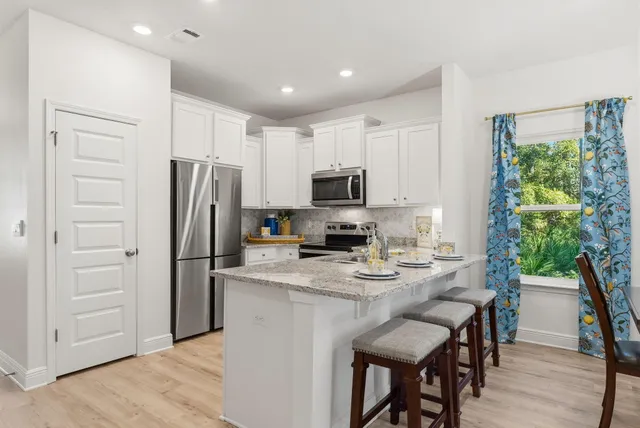 a kitchen with stainless steel appliances a refrigerator stove microwave and cabinets