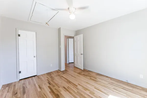 an empty room with a window and wooden floor
