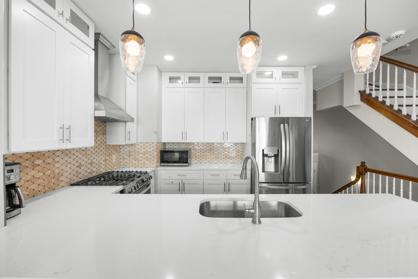 5230 South University Avenue, Unit D Chicago, IL 60615 - Photo 7 of 18 a kitchen with stainless steel appliances kitchen island granite countertop a sink a refrigerator and a granite counter tops