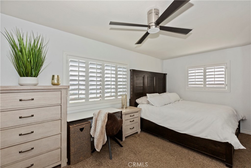 1705 Jeryl Avenue Colton, CA 92324 - Photo 11 of 24 a bedroom with a bed a window and a flat screen television