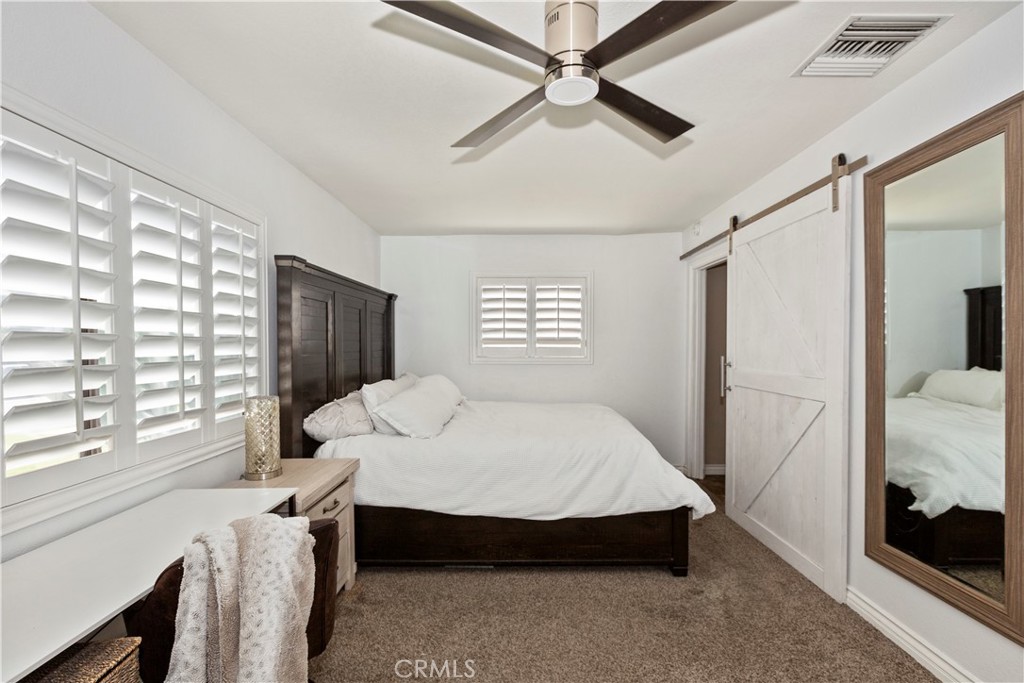 1705 Jeryl Avenue Colton, CA 92324 - Photo 13 of 24 a bedroom with a bed a table and flat screen tv