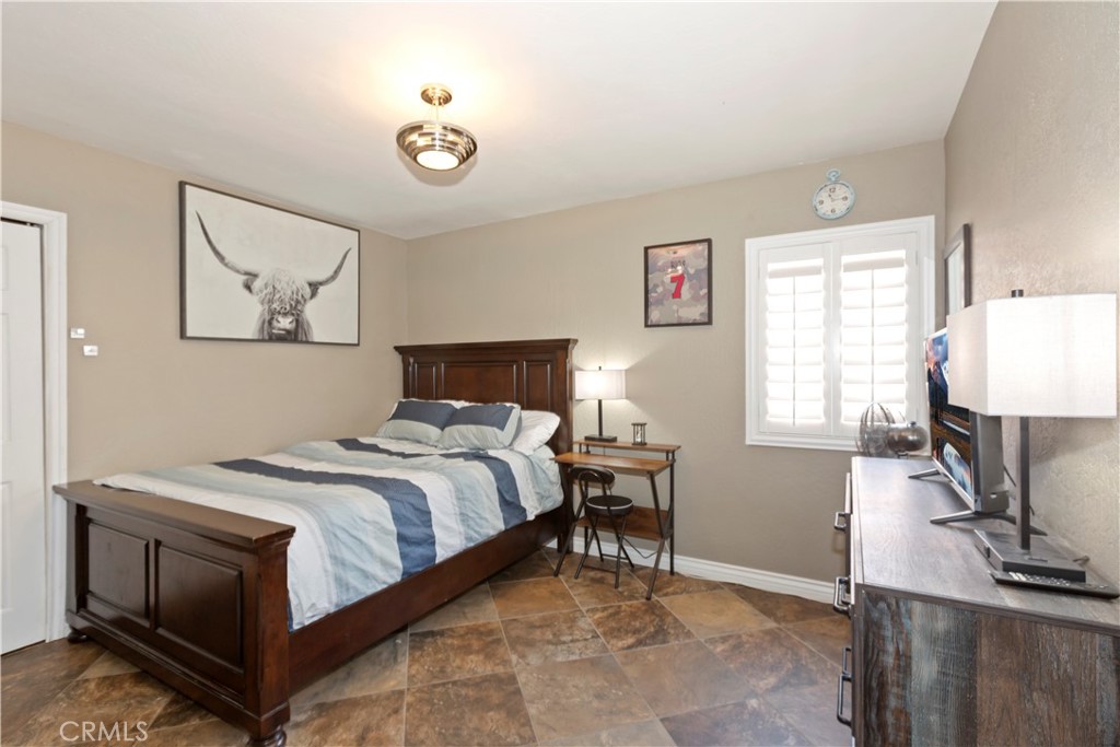 1705 Jeryl Avenue Colton, CA 92324 - Photo 15 of 24 a bedroom with a bed and a flat screen tv