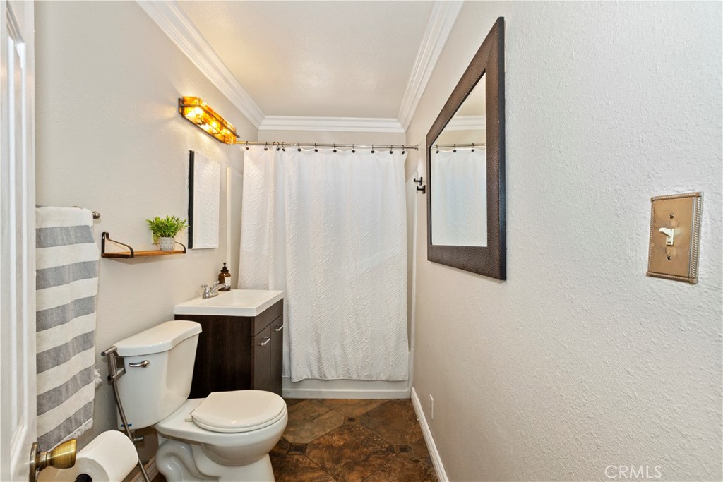 1705 Jeryl Avenue Colton, CA 92324 - Photo 16 of 24 a white toilet sitting next to a bathroom sink