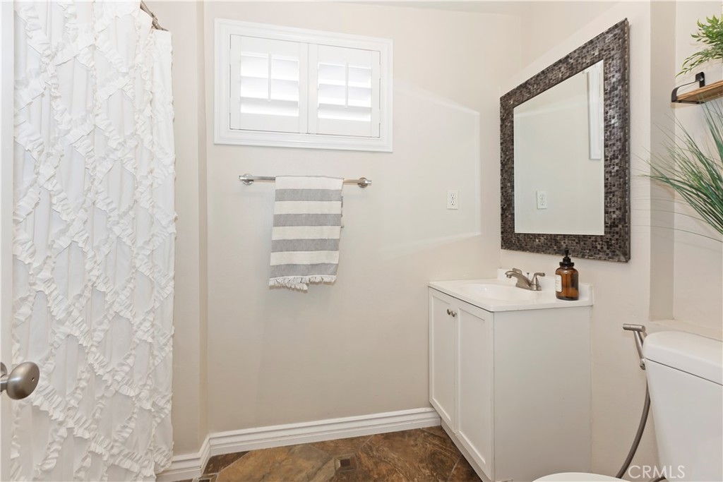 1705 Jeryl Avenue Colton, CA 92324 - Photo 17 of 24 a bathroom with a sink a toilet and mirror