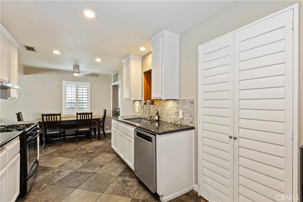 1705 Jeryl Avenue Colton, CA 92324 - Photo 8 of 24 a kitchen with stainless steel appliances kitchen island granite countertop a sink and cabinets