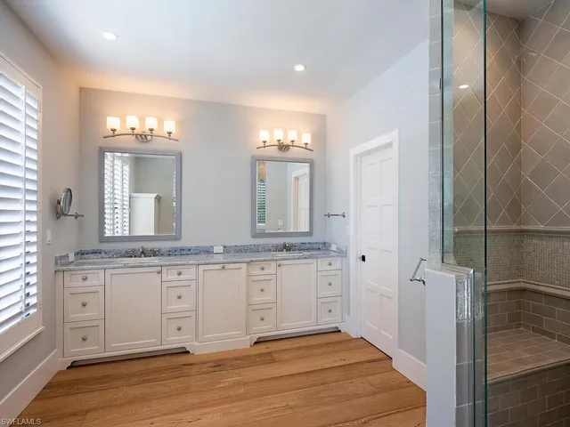 a bedroom with a large bed and a large window