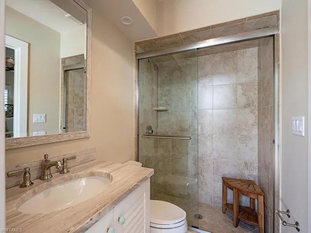 a bedroom with a bed and a ceiling fan