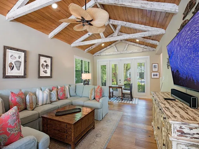 a living room with furniture a rug and a flat screen tv