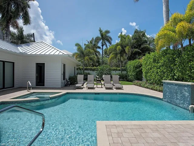 a view of a house with backyard porch and sitting area