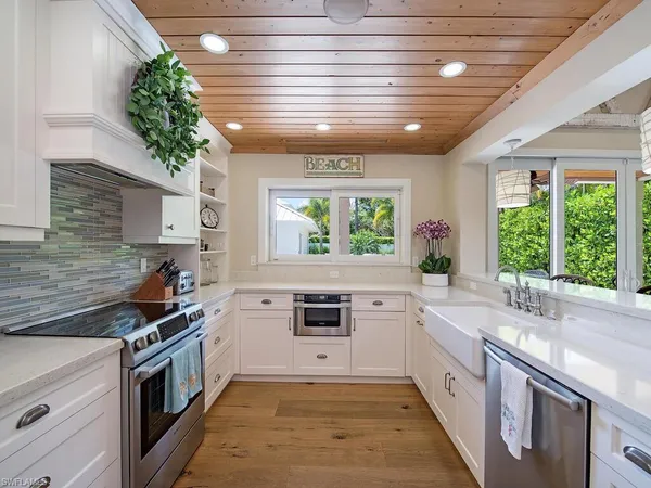 a kitchen with a stove a sink and a window