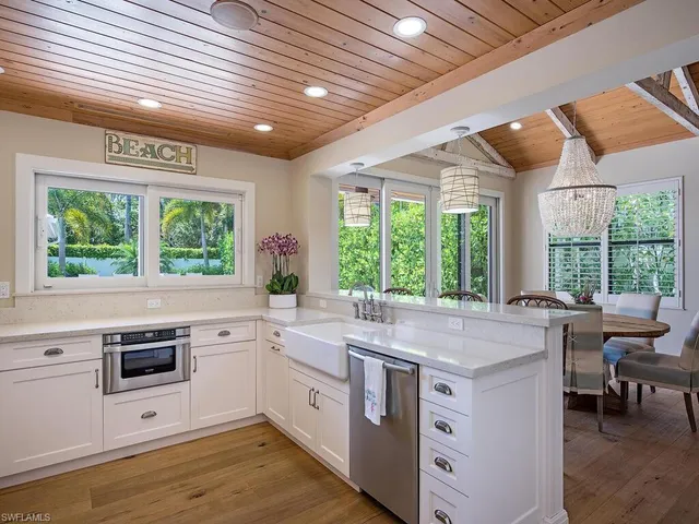 a kitchen with a stove a sink and a microwave