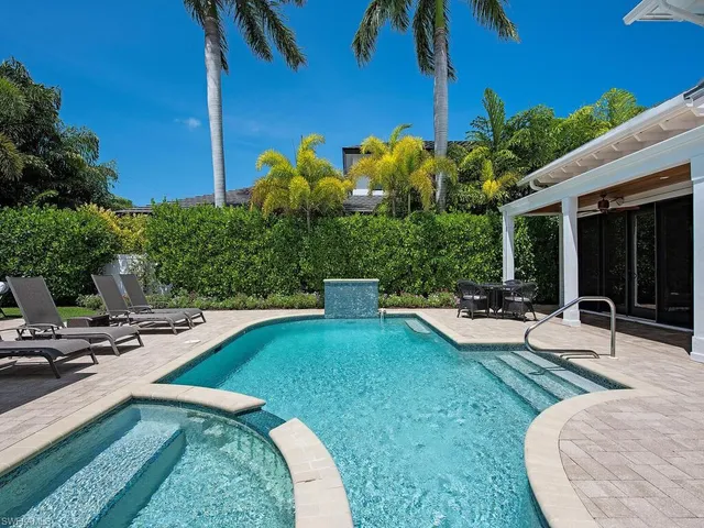 a view of a house with swimming pool and sitting area