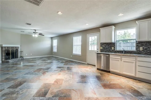 a large kitchen with kitchen island a sink window and stainless steel appliances