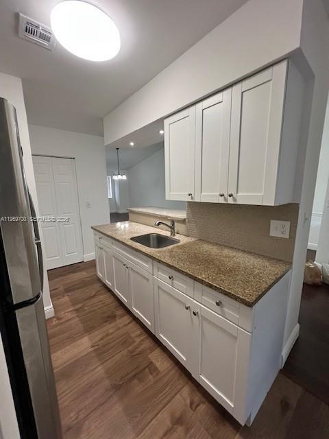 18336 Northwest 68th Avenue, Unit E Hialeah, FL 33015 - Photo 2 of 9 a kitchen with granite countertop a sink a stove and refrigerator