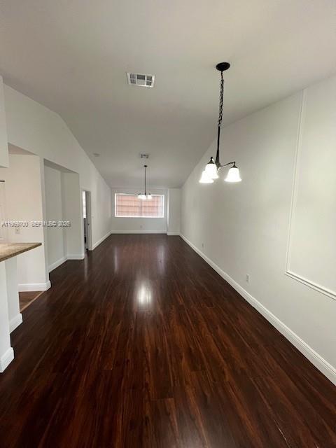 18336 Northwest 68th Avenue, Unit E Hialeah, FL 33015 - Photo 3 of 9 a view of a room with wooden floor ceiling fan and kitchen appliances