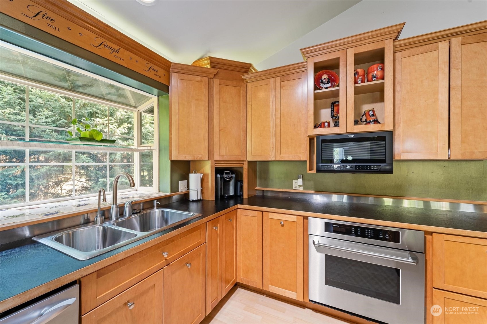 23220 49th Avenue Southeast Bothell, WA 98021 - Photo 16 of 40 a kitchen with stainless steel appliances granite countertop a stove a sink and a microwave